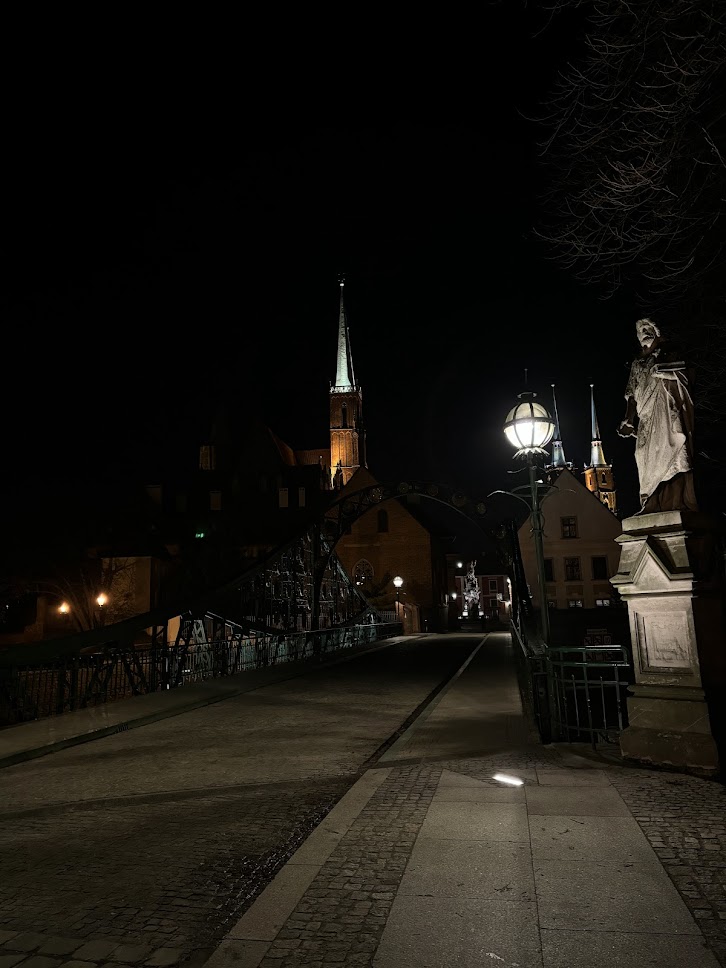 A bridge in Wrocław lit up at night