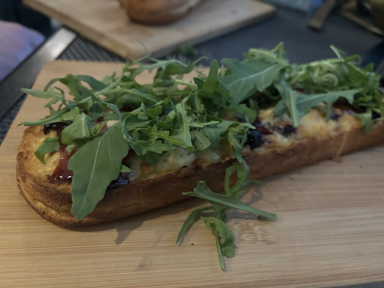 Zapiekanka topped with cheese and mushrooms