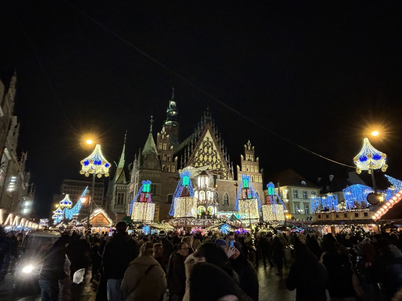 A Christmas market in Wrocław with lights and wooden stalls